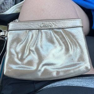 Gold COACH wristlet with wrist strap